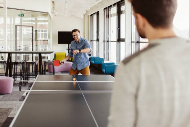istock Office Playtime: Young Friends Enjoying Ping Pong During a Break 2204873337