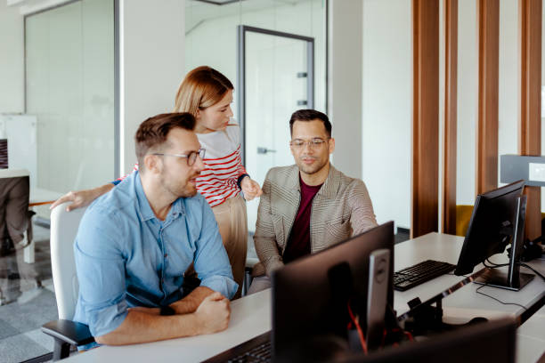 istock Dynamic Development: Team of Coders in a Sleek Office 2204873347