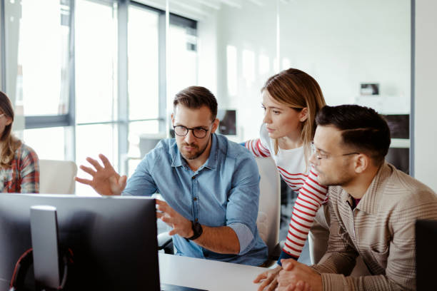 istock Dynamic Development: Team of Coders in a Sleek Office 2204873412