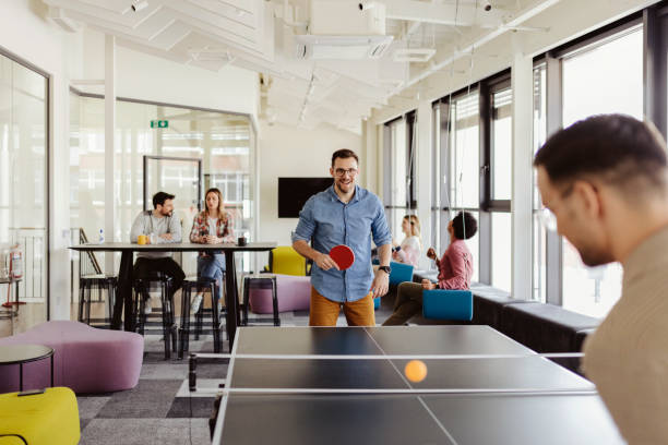 istock Work-Life Balance: Friends Sharing Genuine Laughter Over Ping Pong 2204873421