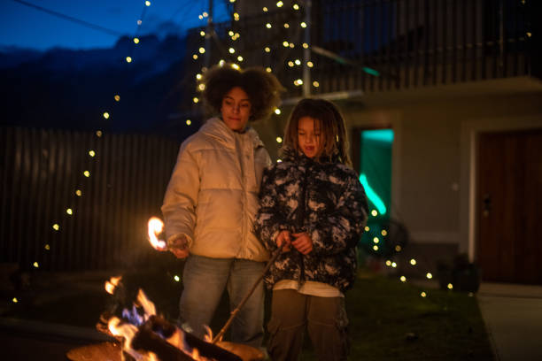 istock Kids enjoying vacation home outdoor fireplace 2204875881