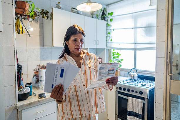 istock Senior woman looking home bills at home 2204876904