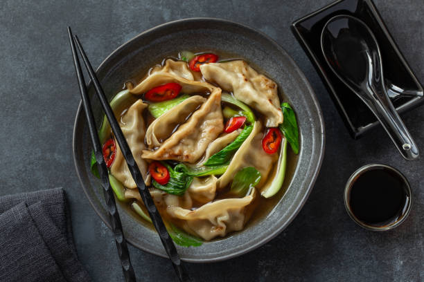 istock spicy gyoza dumplings and pak choi  soup 2204880501