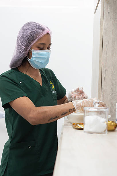 istock Latin nurse wearing protective gear preparing medical equipment 2204882201
