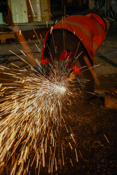 istock A blue-collar worker is cutting and grinding using a grinding wheel in a workshop. Motion. 2204891704