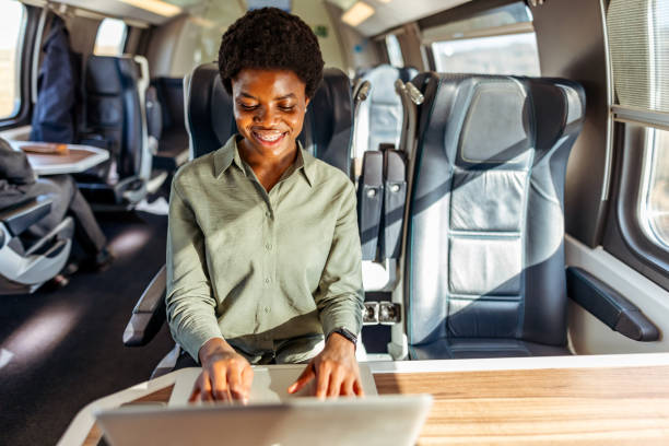 istock Focused Professional Woman Working on Laptop in Modern Train Interior 2204892267