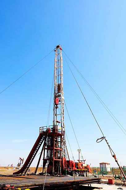 istock Oil drilling derrick and metal pipe 2204896090