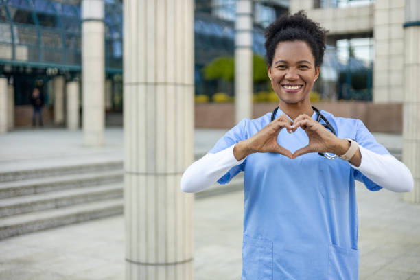 istock Smiling doctor making heart shape with hands outdoors 2204896342
