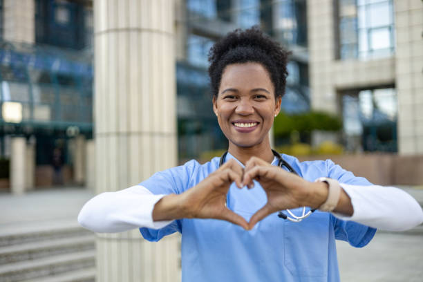 istock Smiling african american doctor making heart shape with hands 2204896362