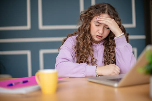 istock Plus size young woman feeling overwhelmed while working at home in a cozy living room 2204898821