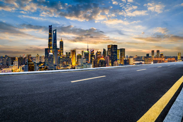 istock Modern city skyline and empty asphalt road in Shanghai at sunset 2204899219