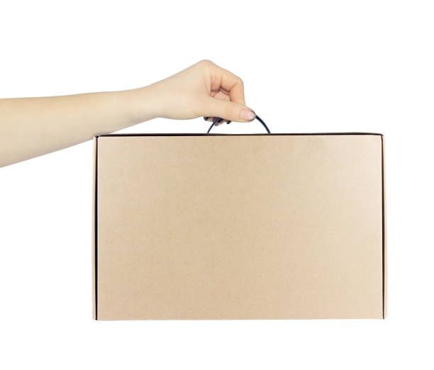 istock cardboard suitcase, brown cardboard box for laptop computer in hand, outstretched hand with cardboard suitcase isolated from background 2204902119