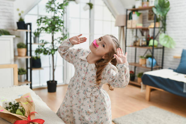 istock Cute Girl Posing Goofy Waving to Camera With Sticky Notes on Her Face 2204903870