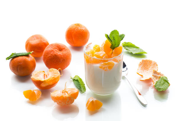 istock Refreshing dessert with tangerines and yogurt, isolated on white background 2204904387