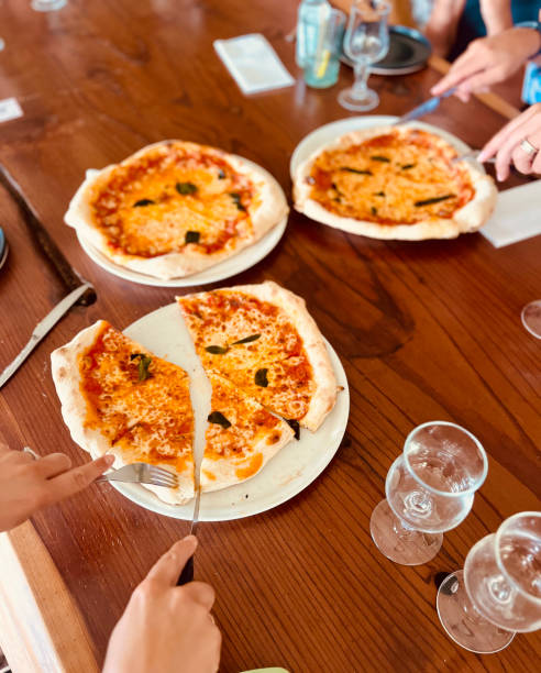 istock Freshly baked wood-fired pizzas on rustic wooden table 2204906712