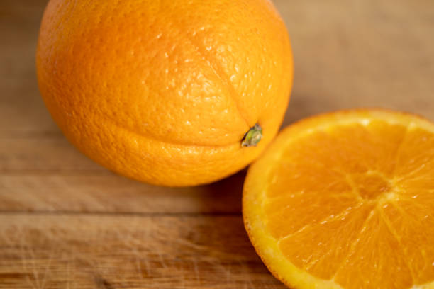 Fresh Orange and Slice on Wooden Surface