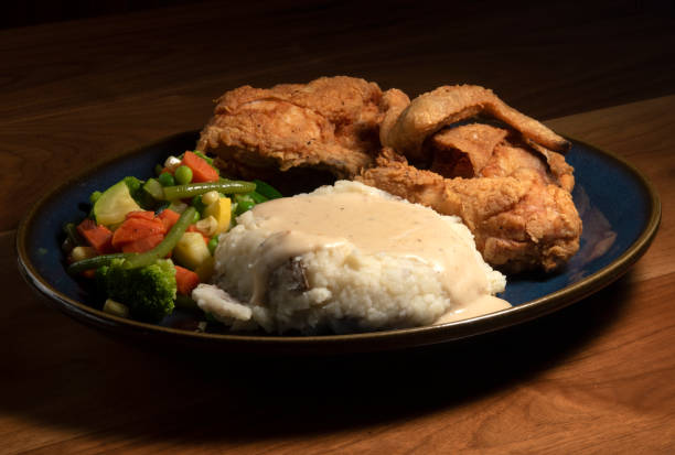 istock Pan Fried Chicken Dinner with Mashed Potatoes and Vegetables Awaits 2204908300