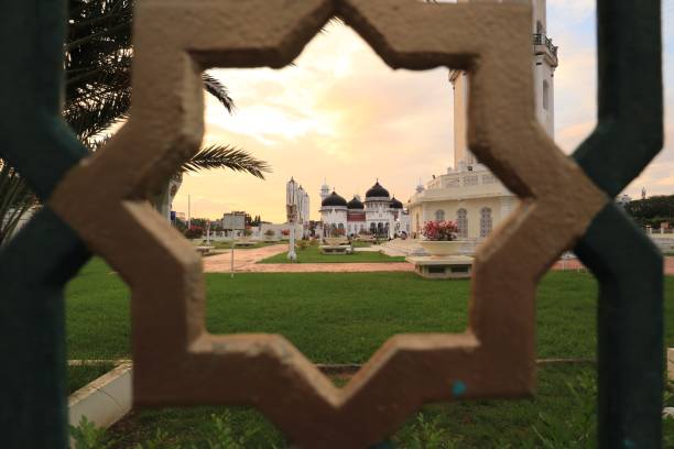 The Baiturrahman Grand Mosque, a proud icon of Banda Aceh, looks even more magnificent as the sun sets. Its signature black domes blend harmoniously with the golden sky, creating a breathtaking panorama. The evening light gently embraces every corner of the mosque, evoking a sense of tranquility and devotion