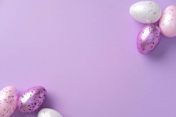 istock Colorful speckled Easter eggs on a pastel purple background. Flat lay, top view, copy space. Minimalistic style 2204908870