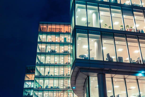 istock Modern office buildings at night showing interior lights in london 2204909376
