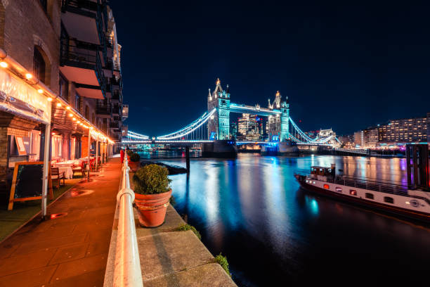 istock Tower bridge illuminating london's night sky over the thames river 2204909447