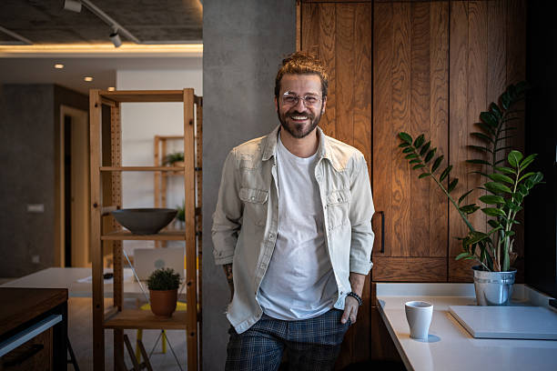 istock Young man smiling in modern designed home office 2204909505