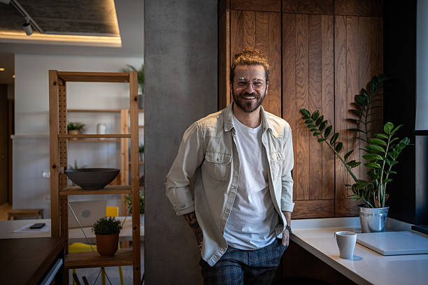 istock Young freelancer smiling in his modern home office 2204909519