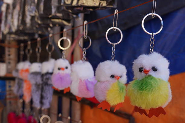 A vibrant green keychain featuring a cute cartoon character frog sitting in it