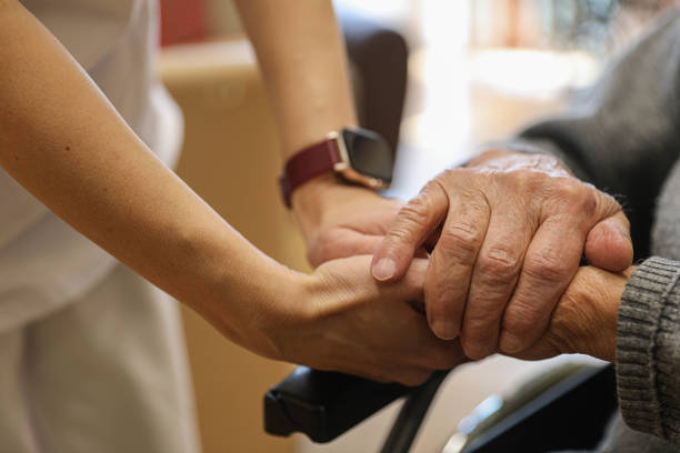 istock Medical staff holding an elderly man's hand, close-up. 2204911280