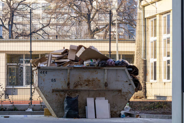 istock a garbage container placed on a construction site on a city street. a container filled with cardboard garbage. construction waste. 2204911338