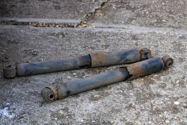 istock Old and rusted car shock absorbers on concrete ground 2204911551