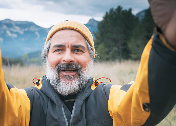 istock Smiling hiker taking a selfie in the mountains 2204912041