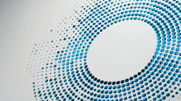 istock Minimalist paper cut-out artwork with circular perforations creating a dynamic abstract pattern in blue and white 2204913857