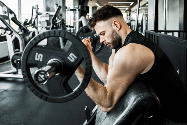 istock Determined Male Athlete Working Out with Weights 2204914570