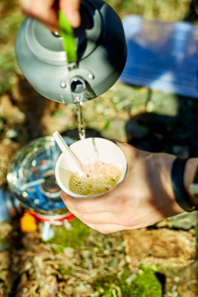 istock Enjoying a warm beverage during a camping trip in the great outdoors on a sunny day 2204916459