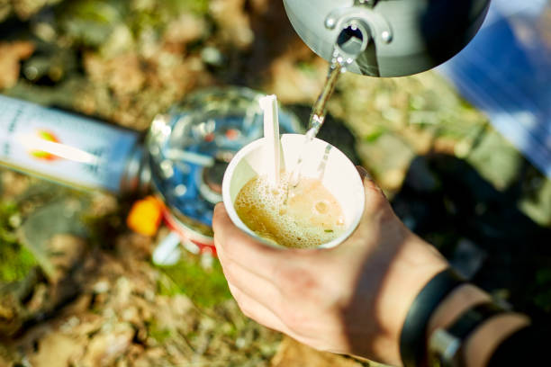 Enjoying a warm beverage during a camping trip in the great outdoors on a sunny day