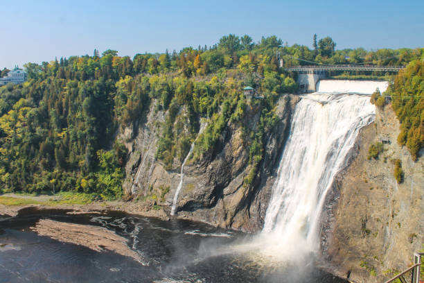 istock Magnificent Montmorency Falls cascading down steep rocky cliffs surrounded by vibrant autumn foliage 2204917048