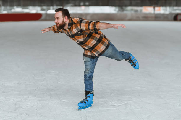 istock Male Ice Skater Perfecting Advanced Moves During Rink Practice 2204917088