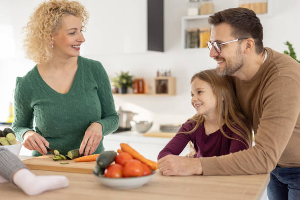 istock Playful Family Interaction While Preparing Fresh Vegetables 2204919869