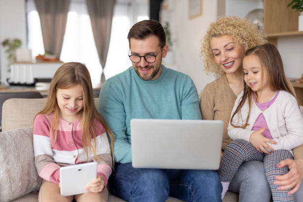 istock A family enjoys a cozy evening with tech and laughter 2204919913