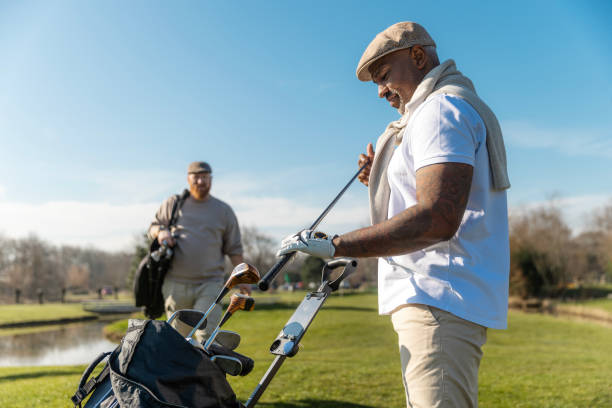 istock Two handsome senior mixed race golfer men enjoying a day of activity on a public golf course in the Netherlands 2204920146