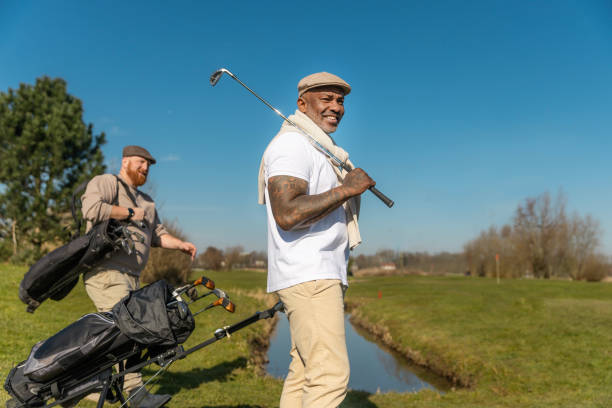 istock Two handsome senior mixed race golfer men enjoying a day of activity on a public golf course in the Netherlands 2204920926
