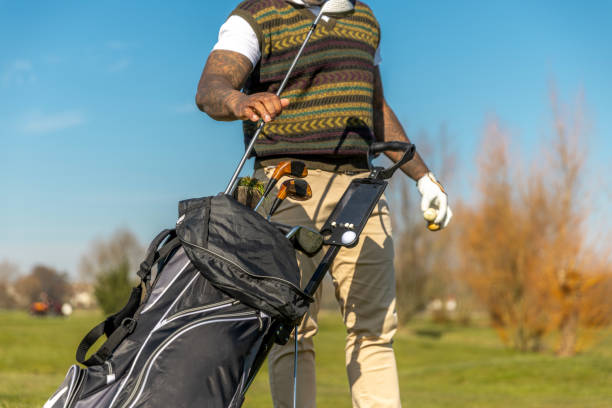 Unknown black golfer man enjoying a day of activity on a public golf course in the Netherlands