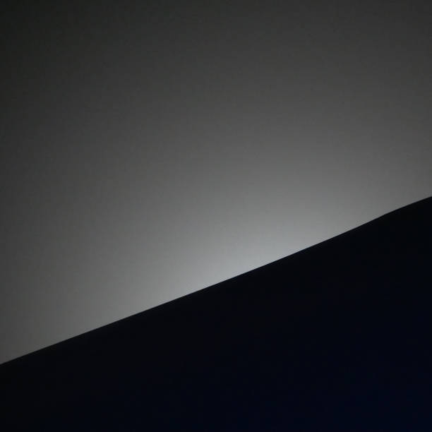 istock The moon hides behind a sloping roof gable 2204924742