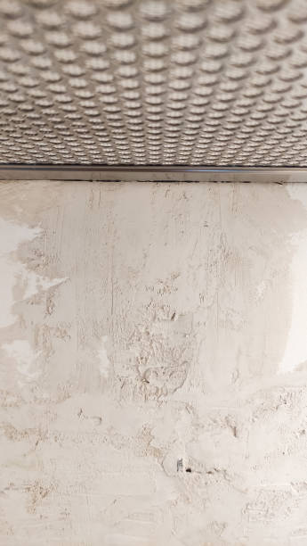 istock Fresh plaster on the wall under a metallic grid in prague 2204925161