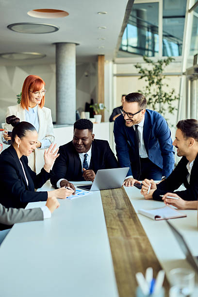Professional Team in Business Meeting Discussing Plans in a Modern Office Environment stock photo