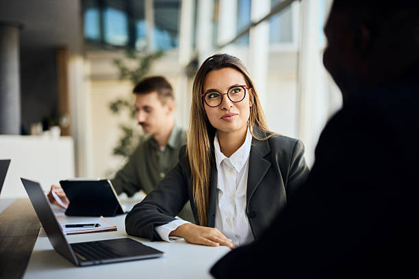 istock Young Professionals Discussing Ideas at a Bright, Modern Office Environment 2204928772