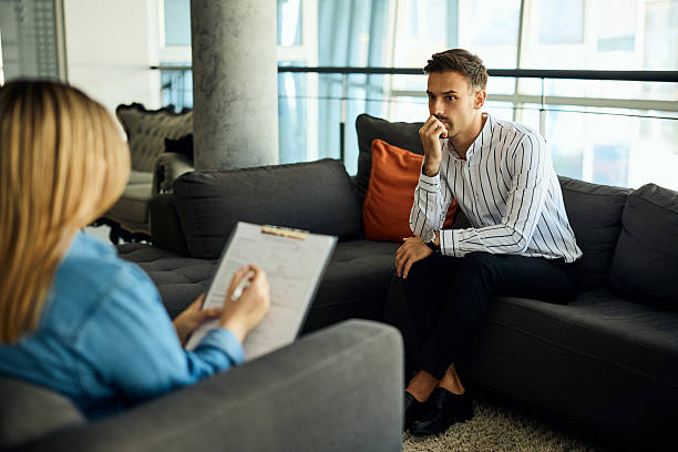 istock Man Receiving Counseling in Modern Office Setting, Showing Thoughtful and Reflective Mood 2204931388