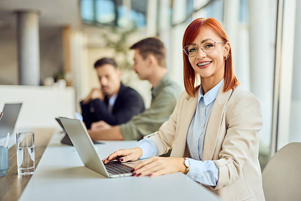 istock Confident Businesswoman Working on Laptop in a Modern Office Environment 2204931392