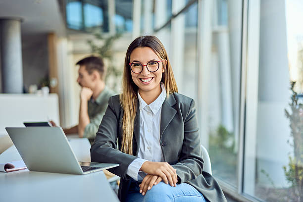 istock Confident Businesswoman Smiling at Work in a Modern Office Setting 2204931415